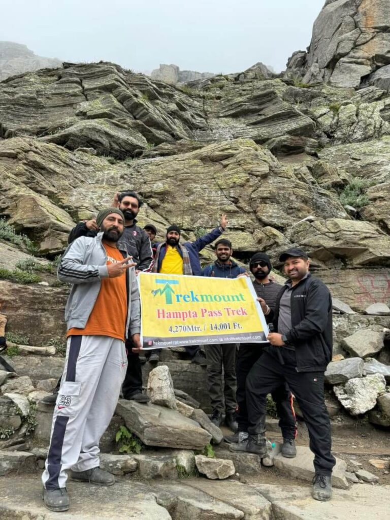 Trekkers navigating rocky terrain on Hampta Pass trekking route